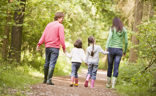 Family walking in woods